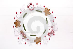 Christmas composition. Round frame made of decorations, fir tree branches, gingerbread man cookies on white background. Winter ho