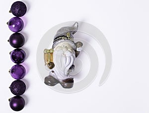 Christmas composition, Santa Claus or leprechaun, Christmas gifts, purple balls on a white background, flat lay