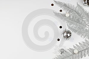 Christmas composition with silver tree branches, christmas ball, snowflakes on white background