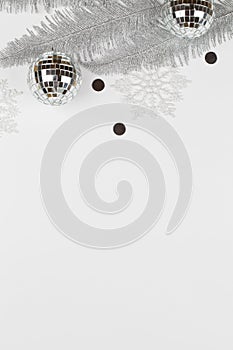 Christmas composition with silver tree branches, snowflakes and balls on white background