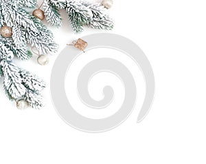 Christmas composition. Snow-covered fir branches, golden balls and mini gifts are on a white background. New Year card. Flat lay,