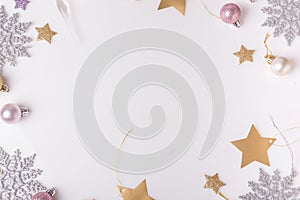 Christmas composition. Spruce branches, xmas tree, xmas pink decor holiday ball with ribbon on white background.