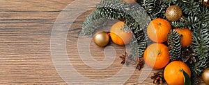 Christmas composition with tangerines on wooden table, flat lay with space for text. Banner design