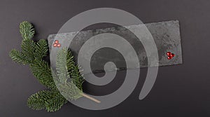 Christmas composition Template, Gemstones and Green branches on stone. Flat lay, top view. Decorative Winter pattern.