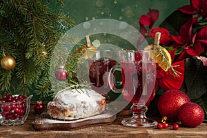 Christmas composition with two mugs of warming vitamin cranberry drink and stollen. Christmas and New Year home holidays concept