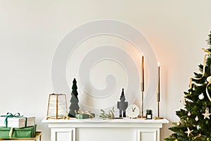 Christmas composition on the white chimney at the living room interior with beautiful decoration.
