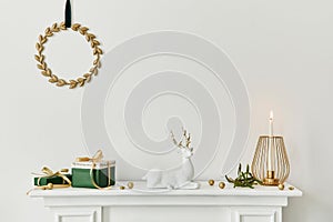 Christmas composition on the white chimney at the living room interior with beautiful decoration. Christmas tree and wreath.