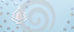 Christmas composition White fir tree on pastel blue background. Snow effect. Horizontal banner. Christmas, winter