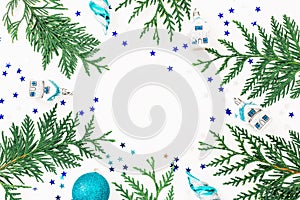 Christmas composition of winter trees, decoration and Christmas baubles on white background. Holiday frame. Flat lay, top view