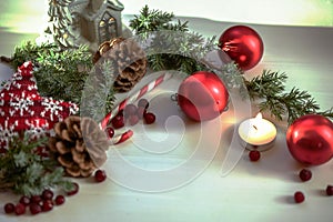 Christmas composition on wooden background with Christmas balls and green branch Christmas tree with pine cones,burning candle