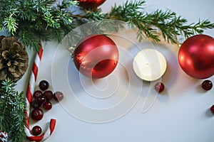 Christmas composition on wooden background with Christmas balls and green branch Christmas tree with pine cones,burning candle