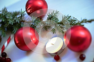 Christmas composition on wooden background with Christmas balls and green branch Christmas tree with pine cones,burning candle