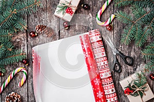 Christmas composition with xmas wrapping, Fir branches, gifts, pine cones, red decorations on wooden background