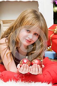 Christmas concept. Beautiful blond girl with a New Years glass spheres