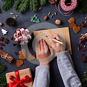 Christmas concept, child hands writing letter to Santa Claus