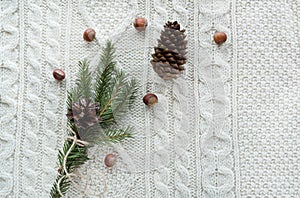 Christmas concept. Christmas bouquet with spruce, fir-tree, snowflakes on white knitted background. Holiday card. Vintage style. F