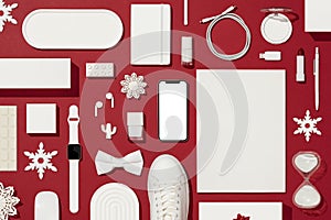 Christmas concept flat lay on red background with white objects