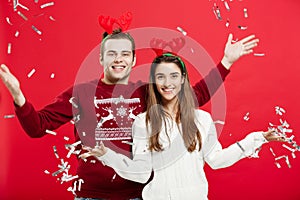 Christmas Concept - Happy caucasian man and woman in reindeer hats celebrating christmas toasting with champagne flutes