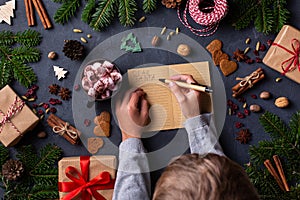 Christmas concept, child hands writing letter to Santa Claus