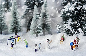 Christmas concept of miniature people hang out in pine woods