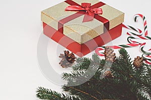 Christmas concept, new year concept. Gift Box, candy staff,candy canes Christmas tree branches.Toned.White background