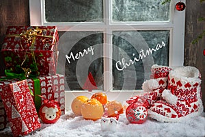 Christmas concept with oranges with snow, wooden window background