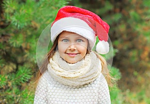 Christmas concept - portrait little girl child in santa red hat