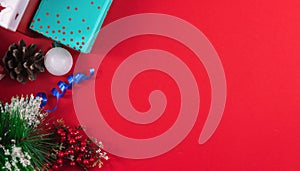Christmas concept on a red cozy background with gifts and decorations, banner top view