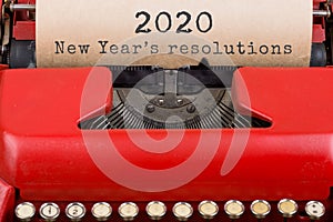 Christmas concept - red typewriter with the text "2020 New Year's resolutions". Close up