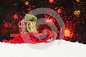 Christmas concept. Santa sleigh driving gold gift and Xmas tree against abstract bokeh light background