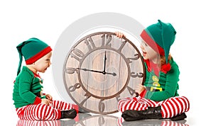 Christmas concept. Two little elf helper of Santa with clock iso