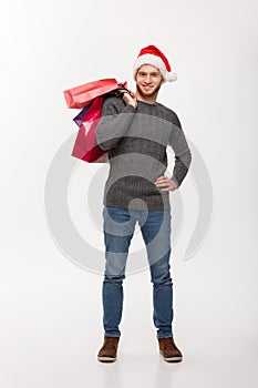 Christmas Concept - Young handsome beard man happy with shopping bag in the hand isolated on white.