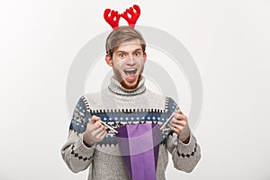Christmas Concept - Young handsome beard man happy with shopping bag in the hand isolated on white.