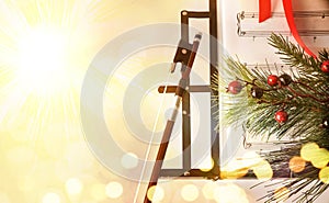 Christmas concert concept with bow and music stand golden background