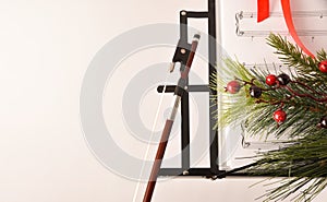 Christmas concert concept with bow and music stand white background