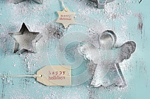 Christmas cookie cutters on vintage aqua blue wood table.