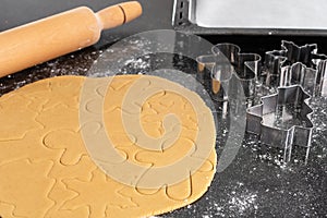 Christmas cookie dough, rolling pin and metal cookie cutters