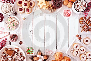 Christmas cookies and baking frame, top view table scene over a white wood background