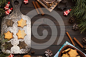 Christmas cookies in the form of stars on a dark wooden background. Place for text.