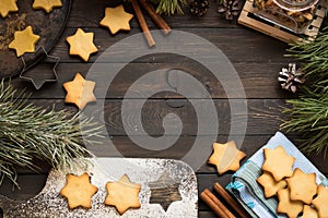 Christmas cookies in the form of stars on a dark wooden background. Place for text.