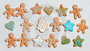 Christmas cookies on a gray background. Homemade ginger cookies with colorful glaze. Gingerbread man, star and Christmas tree. Top