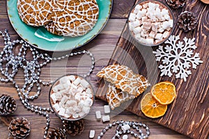 Christmas cookies and hot cocoa with marshmallows in glasses on the table in Christmas decorations