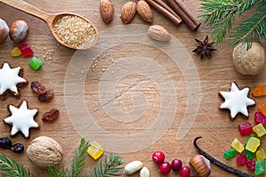 Christmas cookies, nuts and aromatic spices on wooden background, christmas food concept