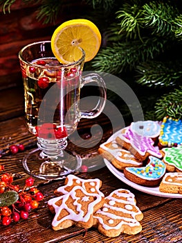 Christmas cookies plate and glass latte mug with lemon.