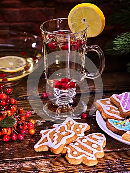 Christmas cookies plate and glass latte mug with lemon.