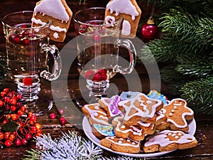 Christmas cookies on plate and two glass latte mug.