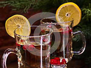 Christmas cookies plate and two glasses mug with cinnamon sticks.