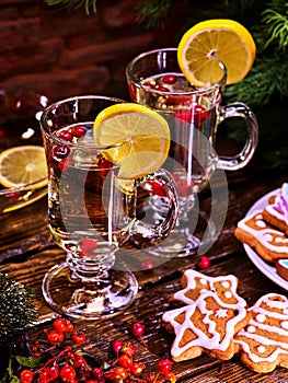 Christmas cookies on plate and two glasses mug with lemon.