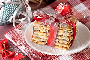 Christmas cookies with a red ribbon on a white plate