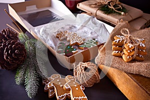 Christmas cookies snowflakes, gingerbread man, tree and gifts box on the wooden table